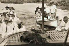 Steam launch towing rowing boats